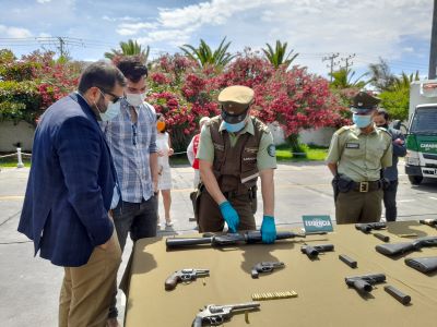 El fiscal Maximiliano Mariángel viendo las armas incautadas cuando fue el procedimiento.